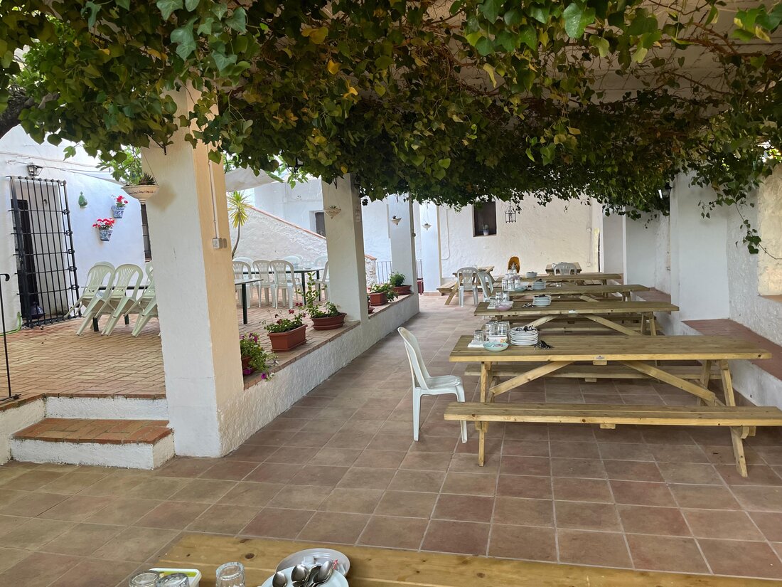 Comedor exterior de la finca bajo un emparrado